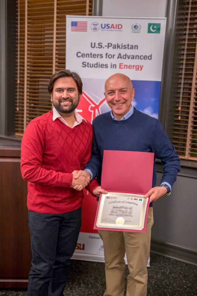 Farooq Umar is congratulated by ASU Professor Bertan Bakkaloglu at the completion of his exchange program at ASU