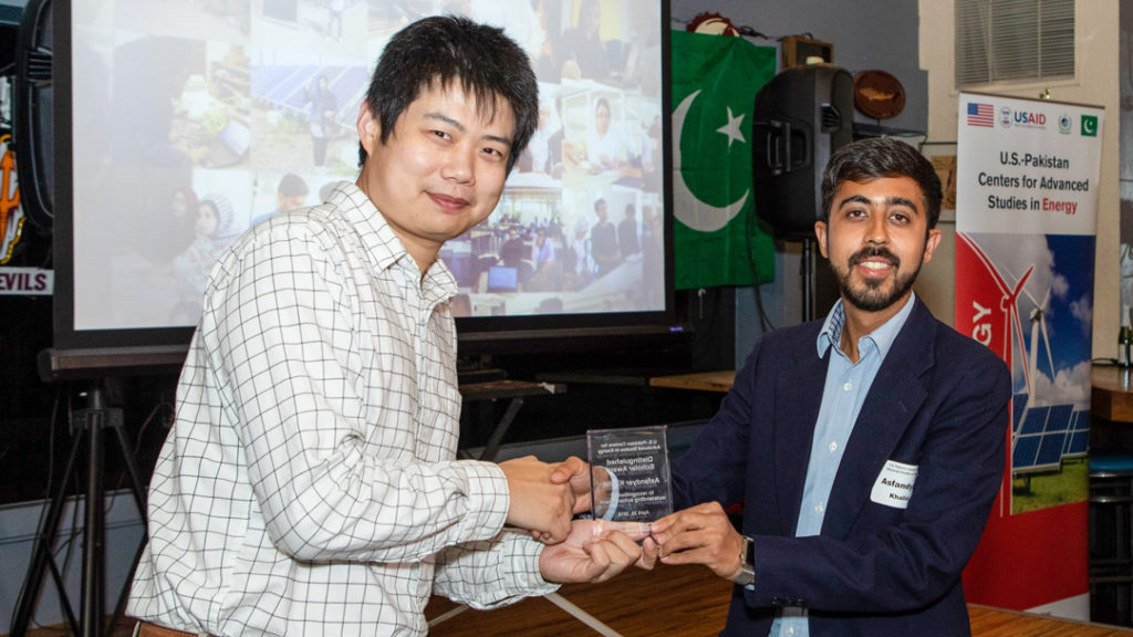 USPCAS-E scholar Asfandyar Khalid receives outstanding scholar award from Dr. Yang Weng